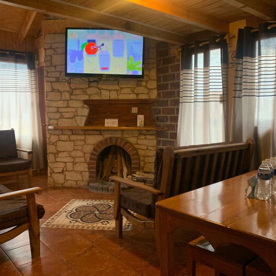 Hotel lounge with stone fireplace and wooden seating