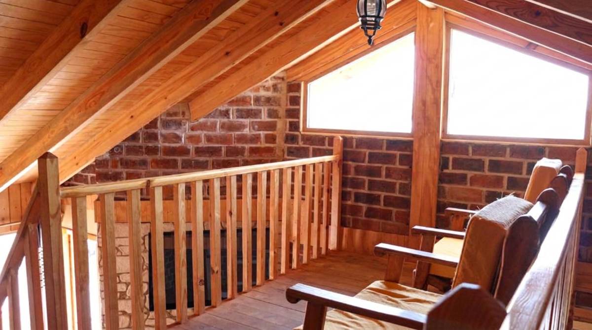 Wooden loft seating area at Hotel y Cabañas Alan